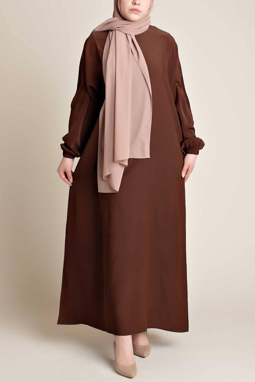 Model wearing a classic Abaya with side pockets in a chocolate brown color - Front pose - Momina Hijabs
