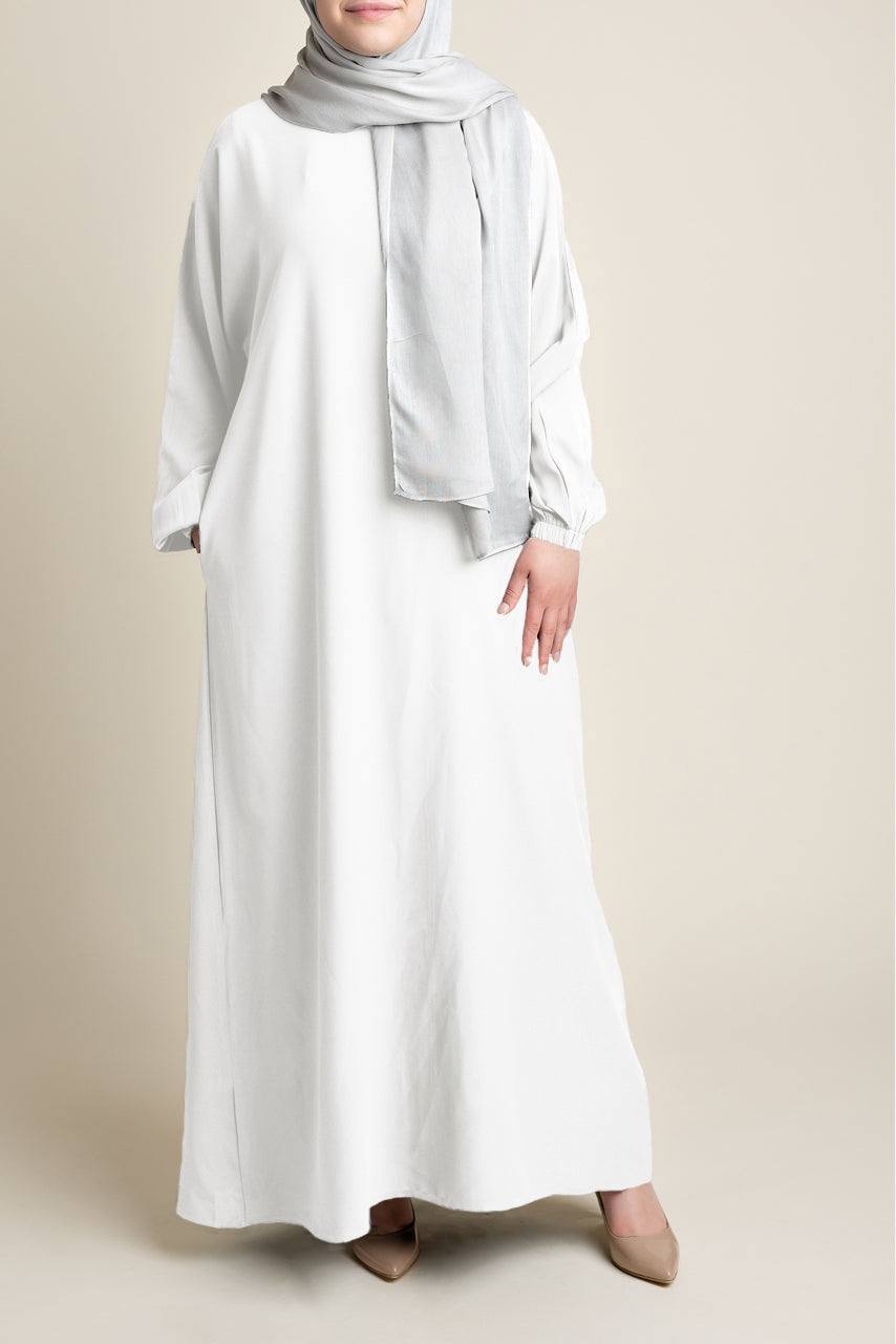Model wearing a classic Abaya with side pockets in white color - Front pose - Momina Hijabs