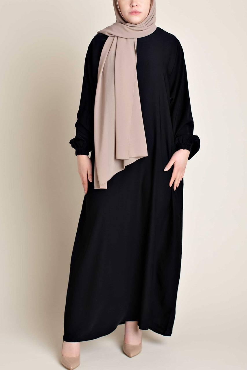 Model wearing a classic Abaya with side pockets in a black color - Front pose - Momina Hijabs