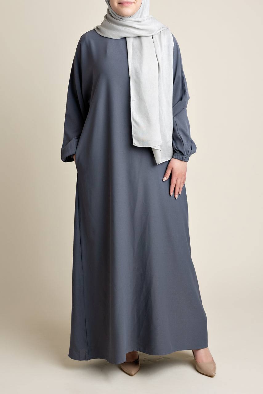 Model wearing a classic Abaya with side pockets in a gray color - Front pose - Momina Hijabs
